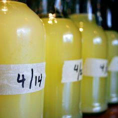 several yellow bottles with labels on them sitting next to each other