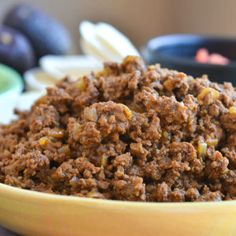 a yellow bowl filled with food on top of a table