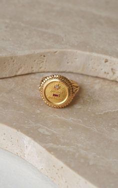 Augis love ring in 18 Kt yellow gold (eagle's head hallmark) decorated with the inscription "+ qu'hier - que tomorrow", set with red stones (synthetic rubies) and an 8x8 cut diamond. French work circa 1950, signed A.AUGIS. Gross weight: 7.79 g Height: 1.80 cm Finger size: 54 (diameter 17.10 / US 6.75). Condition: very light micro scratches on the gold parts, see photos. Luxury Gold Signet Ring With Birthstone, Collectible Gold Ruby Rings, Gold Ruby Ring Stamped 14k, Heirloom Gold Ruby Ring Engraved, Gold Ruby Rings For Collectors, Heirloom Gold Engraved Ruby Ring, Gold Ruby Ring For Promise Occasion, Luxury Gold Rings With Rotating Bezel, Luxury Gold Ruby Ring Birthstone