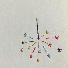 a clock made out of colored crayons on a white paper background with stars