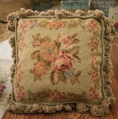 a decorative pillow on a wooden table