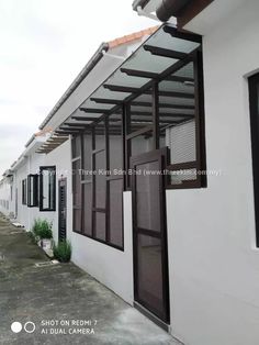 a white house with black shutters and windows