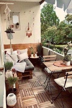 an outdoor patio with wooden flooring and furniture