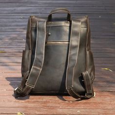 Elevate your daily commute with our Vintage Leather Backpack, seamlessly combining timeless style with practical functionality.   Crafted from heavy duty genuine leather, this rucksack not only exudes a vintage charm but also ensures lasting durability. The spacious interior is thoughtfully designed to accommodate your everyday essentials, featuring a dedicated laptop sleeve (fits laptop up to 15. 6''), wide shoulder straps for comfort, convenient side pockets, and elegant brass metal parts. Outer 100% vegetable tanned, genuine saddle (cowhide) leather, which develops worn look patina. Inner 30% cotton, 70% polyester, cloth lined. Use professional leather caring kit. Patina is the unique character of the saddle leather. Rub at the patina with your fingers to lighten it.  Adjustable wide sh Vintage Leather Backpack, Knit Loungewear, Brand Magazine, Stocking Fillers For Her, Saddle Leather, Brass Metal, Vintage Leather, Gifts For Mum, Cowhide Leather