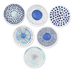 six blue and white plates on a white surface with circles in the middle, all painted by hand