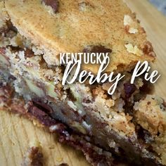 a close up of a piece of cake on a wooden surface with the words kentucky derby pie