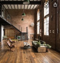 an industrial loft with exposed brick walls and wood flooring is pictured in this image