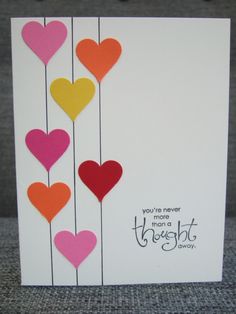 a card with hearts hanging from strings