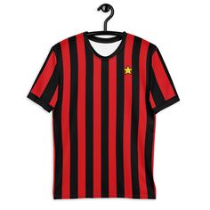 Inspired by the iconic 1982-83 AC Milan home shirt design. Get to know your new favorite tee - it's super smooth, super comfortable, and made from a cotton touch polyester jersey that won't fade after washing.  * 95% polyester, 5% elastane (fabric composition may vary by 1%) * Premium knit mid-weight jersey * Four-way stretch fabric that stretches and recovers on the cross and lengthwise grains * Regular fit * Blank product components in the US and Mexico sourced from the US * Blank product components in the EU sourced from Lithuania Black Jersey Tops With Three Stripes, Black Jersey Top With Three Stripes, Crew Neck Cotton Jersey With Team Logo, Short Sleeve Jersey With Graphic Print For Fans, Graphic Print Short Sleeve Jersey For Fan Gear, Graphic Print Jersey For Fan Apparel, Graphic Print Jersey For Fan Merchandise, Retro Cotton T-shirt With Team Logo, Fan Merchandise Short Sleeve Jersey With Letter Print