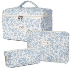 three pieces of blue and white floral print luggage set with matching zippered pouches