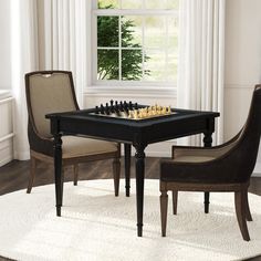 a black table with two chairs around it and a chess board on top of the table