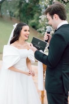 a bride and groom exchanging vows at their wedding