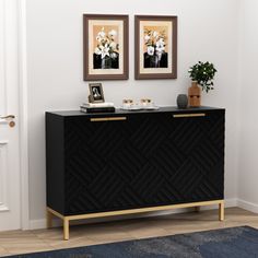 a black and gold sideboard with two pictures above it