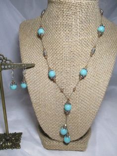 Made by Premier Designs....a  set of Southwestern Themed necklace and earrings...10mm turquoise colored beads with silver tone bead caps and silver tone beads....tiny, shimmering light colored topaz crystal bead accents...strung on tan bead cord..sturdy Lobster Claw clasp...matching 10mm beads with bead caps and the little crystal beads...on silver tone ear wire clips...necklace measures 22" and the section that goes around your neck is 18" BUT you can get an extra 2" with the extension chain....the earrings are dangle and measure 1 1/2" in drop length and 3/4" in length alone...in great shape. Topaz Crystal, Shimmer Lights, Premier Designs, Necklace And Earrings, Bead Caps, Turquoise Color, Ear Wire, Lobster Claw, Crystal Beads