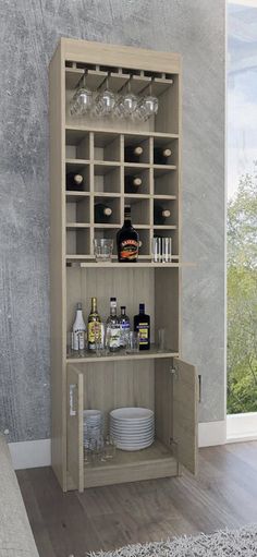 an open cabinet with bottles and glasses on it in a room that has wood floors