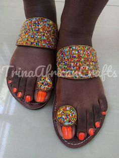 This sandals are a beautiful work of art carefully handcrafted in Kenya to suit your versatile needs. The pure leather is soft to ensure comfortability to the wearer. The sandal is strong and durable made with the African rough roads in mind; additionally they have a fine touch of bead work to complete it's beautiful look. Available in all sizes. 😊 Handmade Open Toe Sandals For Festivals, Traditional Open Toe Barefoot Sandals For Festivals, Artisan Open Toe Toe-ring Sandals For Summer, Bohemian Beaded Leather Toe Ring Sandals, Artisan Multicolor Open Toe Sandals, Traditional Adjustable Slip-on Sandals, Traditional Beaded Leather Toe Ring Sandals, Multicolor Toe Ring Sandals With Single Strap, Traditional Sandals With Adjustable Single Toe Strap