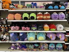 several shelves in a store filled with lots of different colored slippers and pumpkins