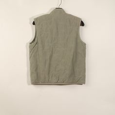 Unworn. Over dyed. Decent Condition. Final Sale. Sage 100% cotton canvas Padded Hits at mid-hip Cross Chest: 19.5" Medium Wash Cotton Vest With Pockets, Sleeveless Washed Cotton Vest, Solid Moisture-wicking Sleeveless Vest, Khaki Military Vest With Pockets, Military Cotton Vest With Cargo Pockets, Padded Vest, Final Sale, Sleeveless Top, Cotton Canvas