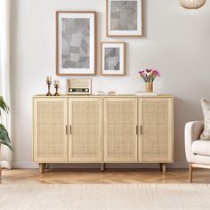 a living room with white walls and pictures on the wall above it, including a wicker sideboard