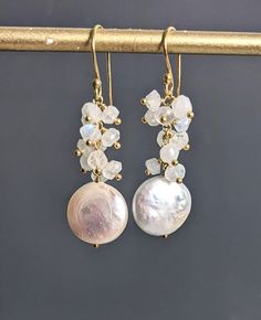 Bridal White Coin Pearl Moonstone 24 K Gold Filled Long Earring, Freshwater Pearl Gold Filled Wire Wrap Cluster Earrings, June Birthstone. They measure 1 9/10'' ( 49 mm.) long, including ear wire. * Processing time is 3 - 5 days.  * US orders are shipped first class mail. * International orders are shipped first class international. * Shipping upgrades are available at checkout. Thank you for visiting my listing! Have a wonderful day! Dangle Earrings With Stones For Wedding, Dangle Stone Earrings For Wedding, White Pearl Earrings With Natural Stones For Wedding, White Natural Stone Wedding Earrings, Drop Earrings With Natural Stones For Wedding, White Natural Stone Pearl Earrings For Wedding, White Natural Stones Earrings For Wedding, Natural Stone Drop Earrings For Wedding, White Gemstone Round Bridal Earrings