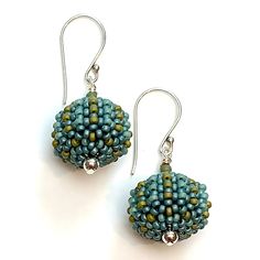 Beaded Earrings - Small glass beads in luxe Orchid hues or warm Aegean blue-green are hand woven one at a time around lightweight acrylic orbs. Sterling silver accent beads add extra polish. Comfortable sterling silver ear wires complete the look. Artisan Blue Beaded Round Earrings, Blue Round Beaded Earrings With Spacer Beads, Turquoise Large Beads Drop Earrings, Turquoise Drop Earrings With Large Beads, Artisan Blue Beaded Earrings, Green Artisan Round Bead Earrings, Adjustable Green Beaded Earrings With Large Beads, Orb Earrings, Aegean Blue