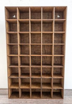 a wooden bookcase with many shelves on it's sides and one shelf in the middle