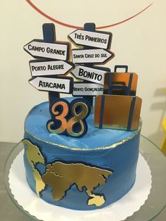 there is a blue cake with many signs on it