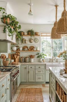 a kitchen filled with lots of green cupboards and counter top space next to a window