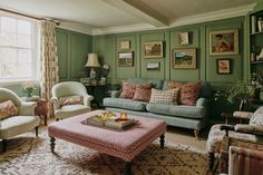 a living room filled with furniture and green walls