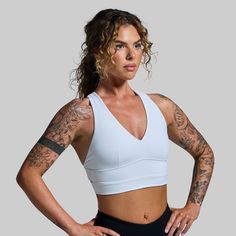 With a longer body and crossed straps in the back, this sports bra was designed with the perfect balance of flexibility and support. Made with our signature BPLegacy fabric to move with you and provide ample support for nearly any activity. Bonus, this sports bra can double as a bathing suit top. White Sports Bra With Built-in Bra For Gym, White Breathable Sports Bra For Yoga, Breathable White Sports Bra For Yoga, Compressive White Sports Bra For Gym, White Sports Bra With Light Support For Exercise, White Sports Bra For Light Exercise With Light Support, White Yoga Sports Bra With Built-in Padding, White High Stretch Sports Bra For Gym, Functional White Sports Bra For Workout