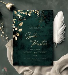 an elegant wedding card with feathers and flowers