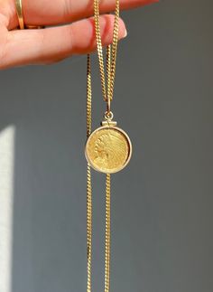 * Antique 1908 American near solid gold Liberty Native American Head 2 1/2 dollar coin (first year these were produced) in a 14 carat gold frame pendant, strung on a mid-century Italian Uno-a-Erre 18 carat gold curb link chain. Coin is in fair condition from over a century of love, wear, and use, but please note the solder mark[?] on the back of the coin. See pictures for closer looks. * Chain is stamped with "750", "1", "AR", a star, and hallmarked "UNO-A-ERRE". * Measurements:   Pendant- 1.15 inches long including the jump bail, 0.95 inch without x 0.72 inches wide   Chain- 24 inches long x 2 millimeters  * Weight:    Pendant- 5.8     Chain- 9.4     Total- 15.2 grams Chain Collar, Indian Head, Link Chain Necklace, Coin Jewelry, Coin Pendant, Chain Link Necklace, Link Chain, Gold Frame, Gold Pendant