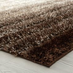 a brown and white rug on the floor