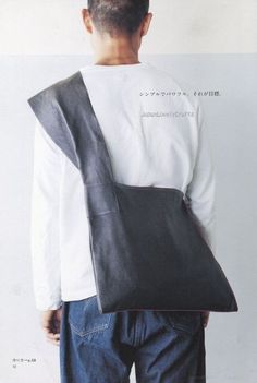 the back of a man wearing a black leather bag