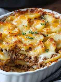 a casserole dish filled with meat and cheese