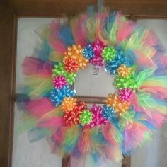 a colorful wreath is hanging on the door