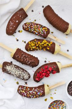 chocolate covered ice cream sticks with sprinkles and confetti on them