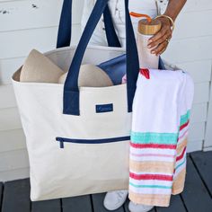 It's true! Our Beyond Basics Tote is far from basic. This oversized tote is huge and durable! The interior is lined with vinyl for easy cleaning, and the exterior has a waxed canvas finish to wipe away any stains! Perfect for packing for a weekend getaway, day to the beach, and more! Pair with the matching Beyond Basics Organizer Bag, Duffel, Pouch, and Essential Bag for a complete travel set. Designed exclusively for Tate + Zoey by Gifted Artist, mb greene Waxed canvas easy-to-clean exterior Vi Weekend Canvas Tote Bag With Reinforced Handles, Weekend Canvas Bag With Reinforced Handles, Eco-friendly Canvas Weekend Bags, Weekend Tote Bag With Zipper Pocket, Weekend Canvas Bag With Removable Pouch, Weekend Canvas Bags With Removable Pouch, Canvas Bag With Removable Pouch For Weekend, Eco-friendly Canvas Bag For Weekend Trips, Special Colors