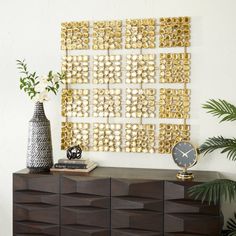 a modern dresser with gold and white decorations on it