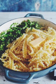 pasta with parmesan cheese and broccoli in a skillet