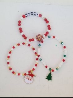 three beaded bracelets with christmas decorations on them