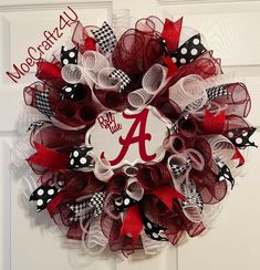 a red and white mesh wreath with the letter a on it's front door