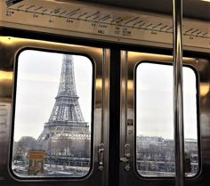 the eiffel tower is seen through two windows