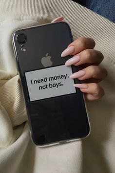 a woman holding an iphone case with the words i need money, not boys on it