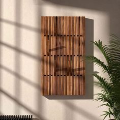 a wooden panel mounted to the side of a wall next to a potted plant