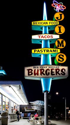 a sign that says mexican food tacos and pasta sits in front of a restaurant