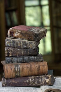 several old books stacked on top of each other