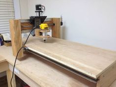 a workbench with a driller and some wood planks on it's sides