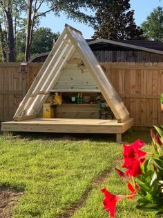 a small wooden structure in the middle of a yard