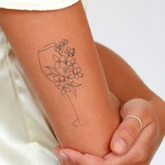 a woman with a flower tattoo on her arm